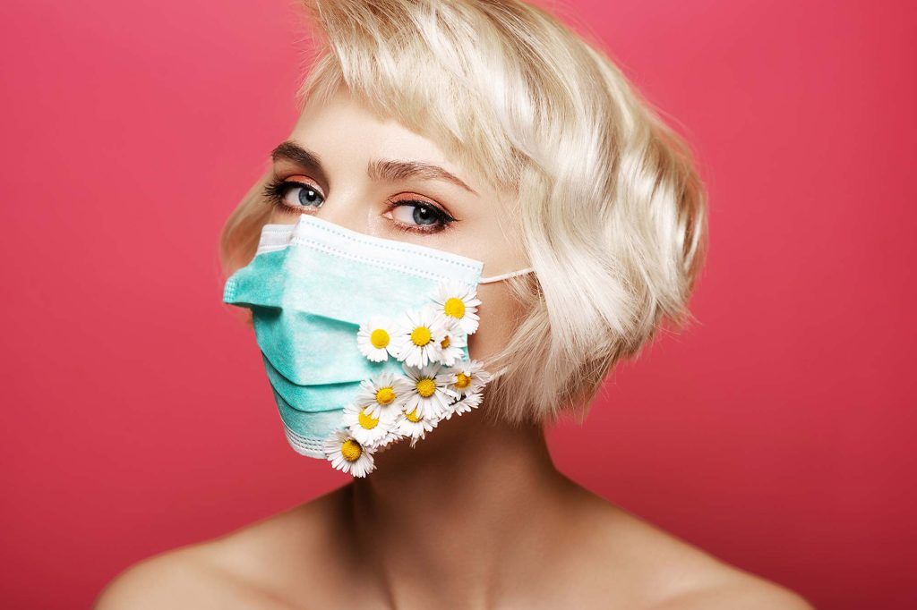 Woman wearing floral face mask during Covid-19 cosmetic industry changes