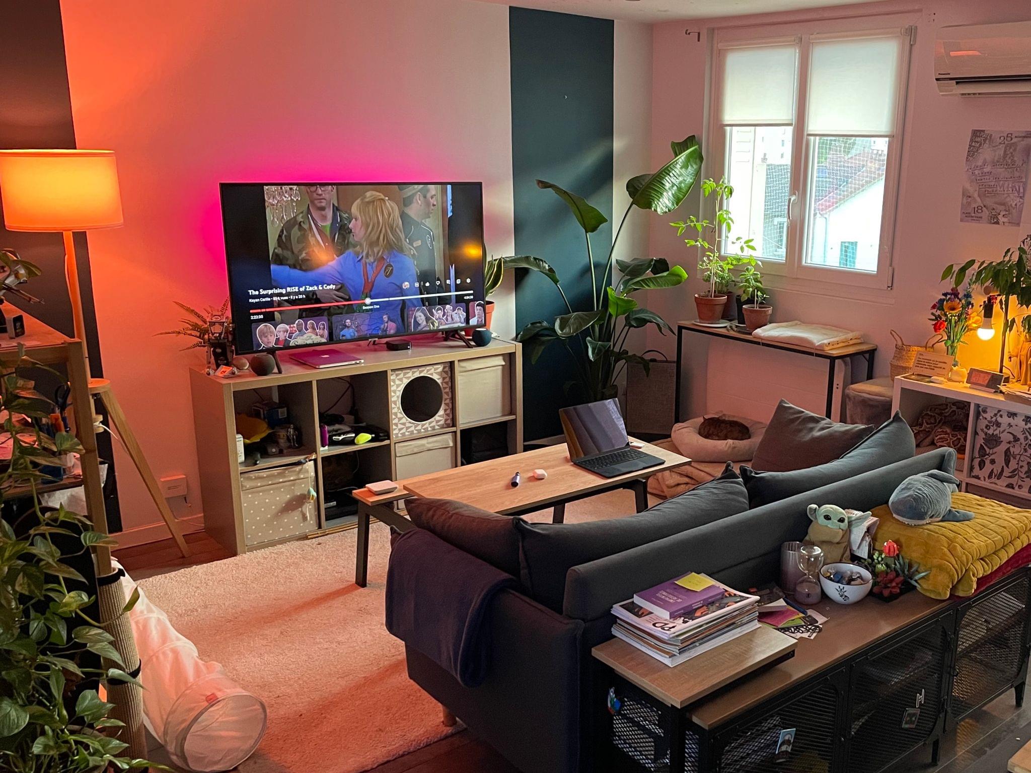 Our Nanoleaf Lightstrip emits a soft pink light behind the TV in the evening.