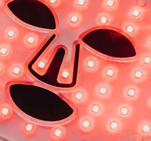 Red LED therapy mask with cutouts for eyes, nose and mouth
