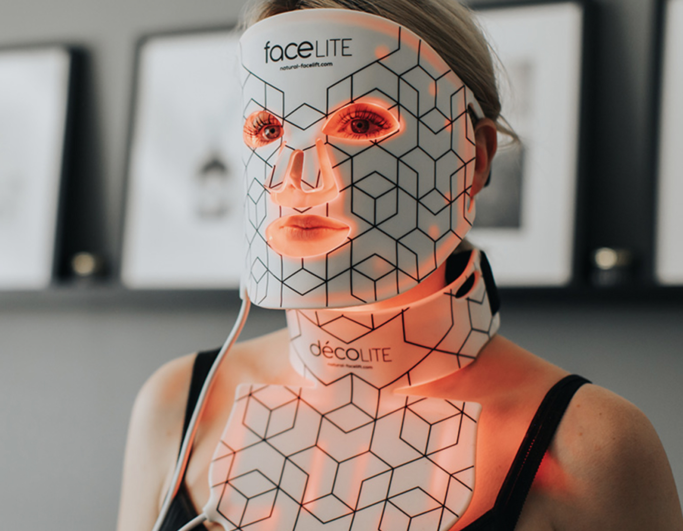Woman wearing FaceLite LED face mask and Décolite neck device for skincare treatment