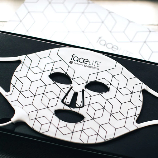 FaceLite LED light therapy mask placed on product packaging